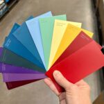 hand holding paper color sample sheets